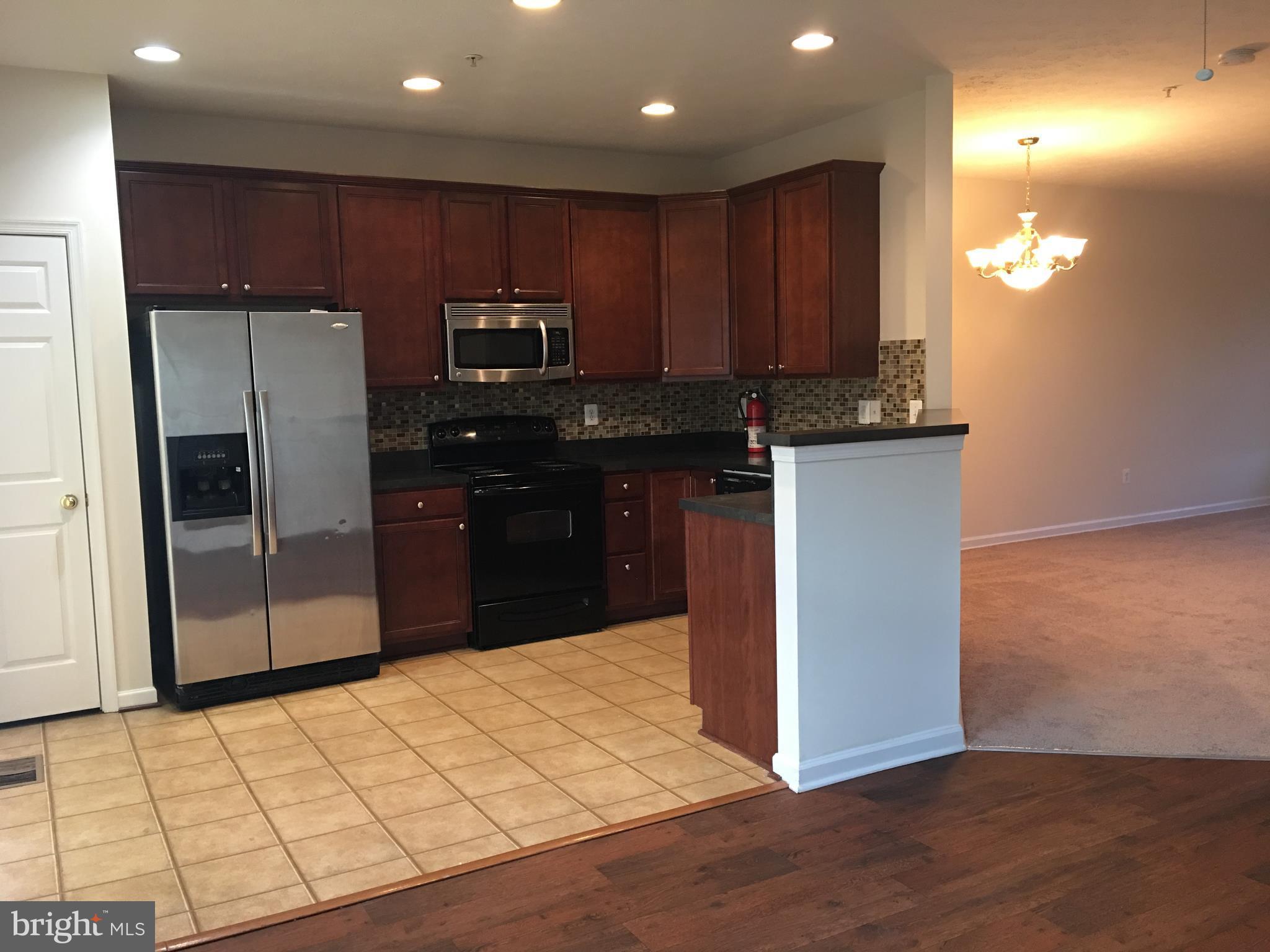 9609 Davison Road Baltimore, MD 21220 - Photo 2 of 21 a kitchen with kitchen island a counter top space cabinets and stainless steel appliances