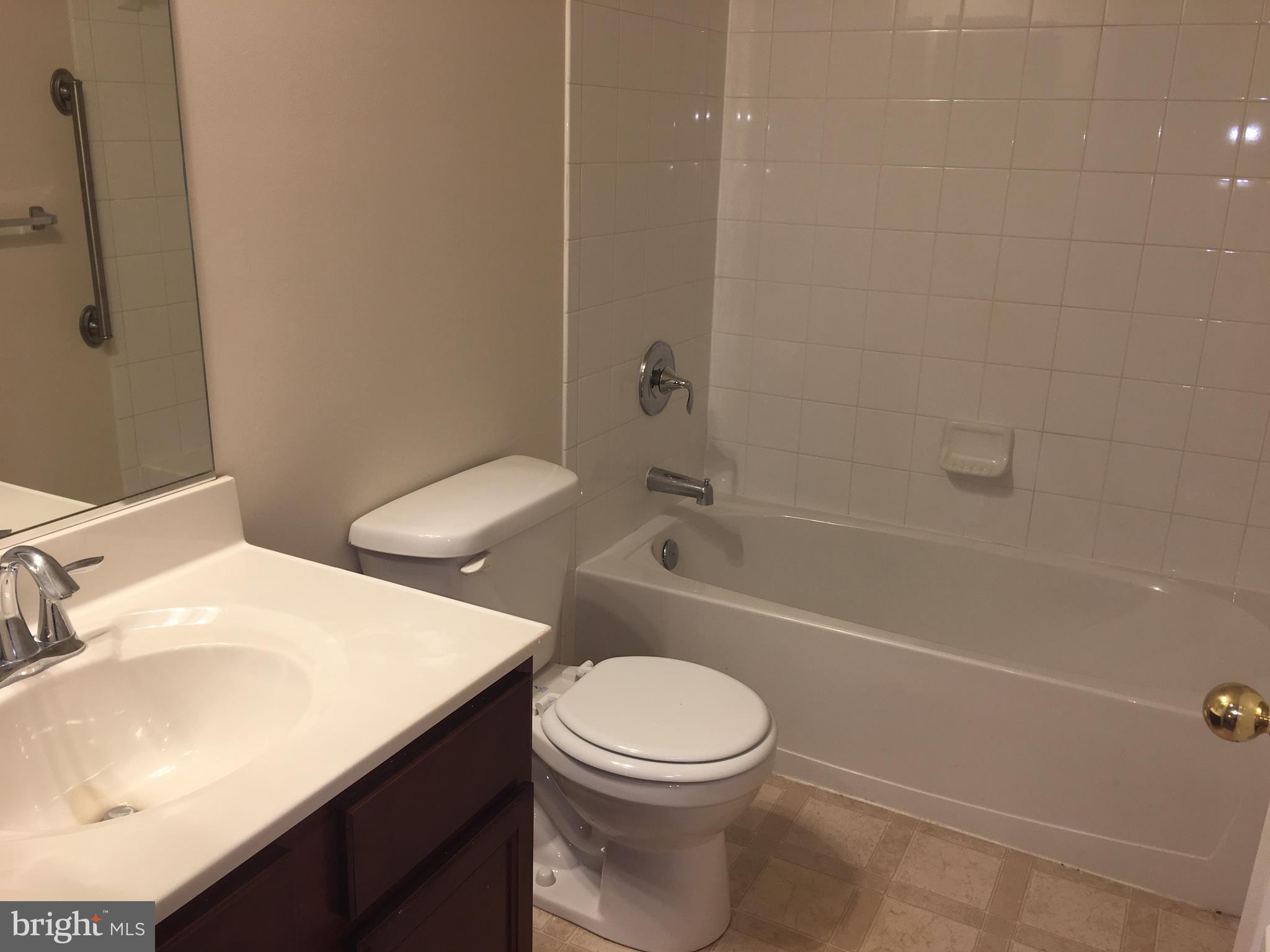 9609 Davison Road Baltimore, MD 21220 - Photo 11 of 21 a bathroom with a sink a toilet and a bathtub