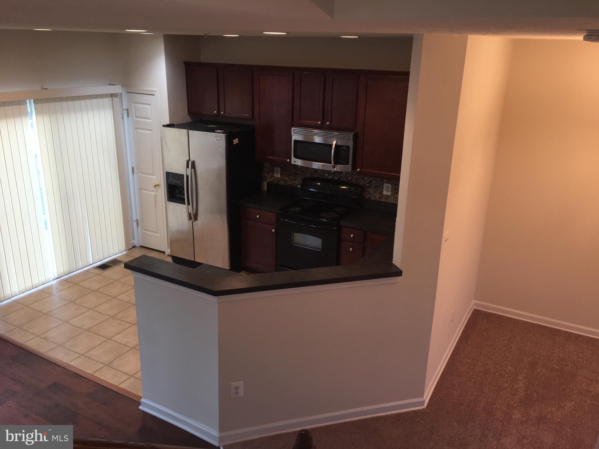 9609 Davison Road Baltimore, MD 21220 - Photo 15 of 21 a kitchen with stainless steel appliances granite countertop a refrigerator and a stove