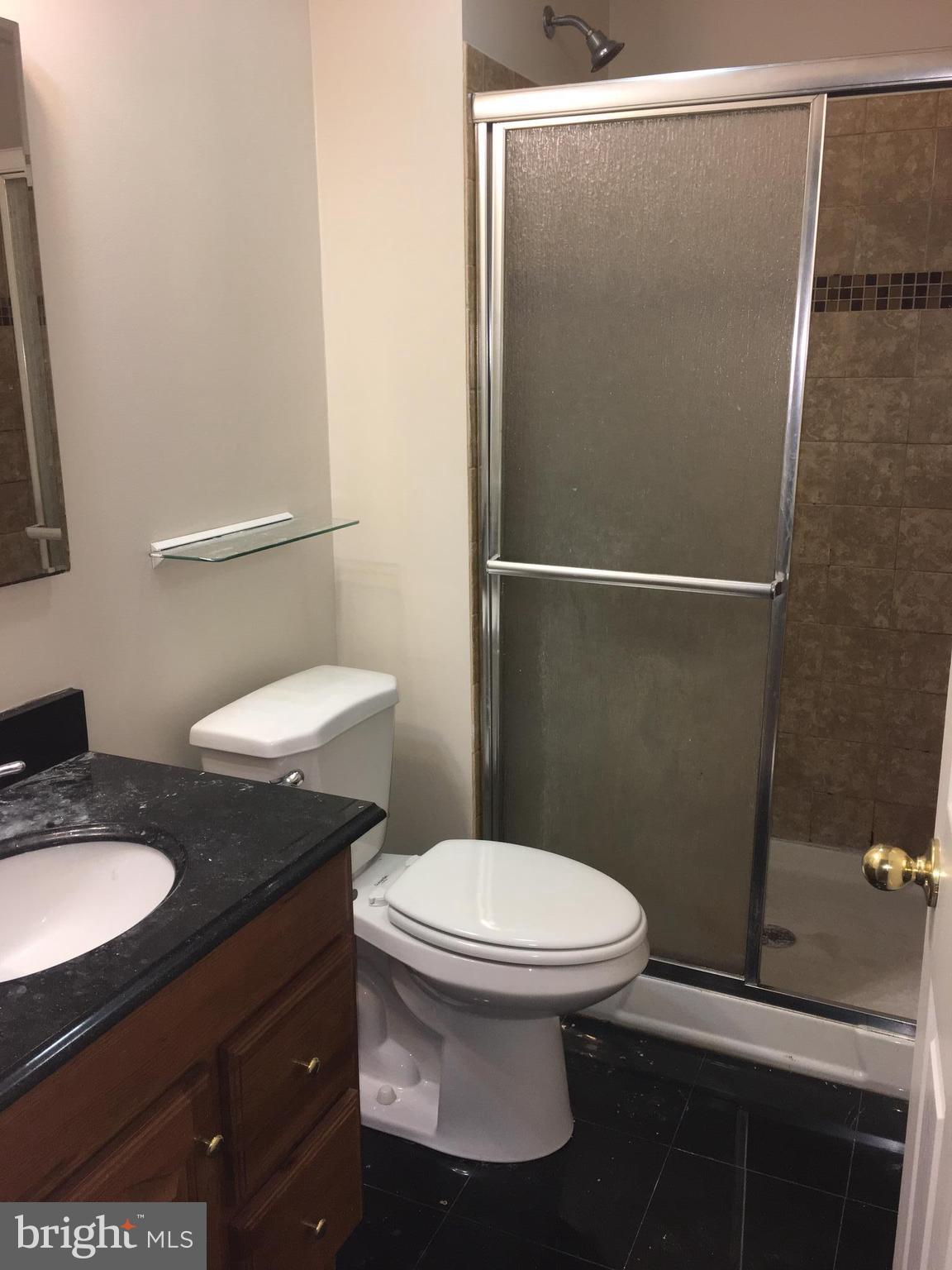 9609 Davison Road Baltimore, MD 21220 - Photo 17 of 21 a bathroom with a granite countertop toilet and a sink
