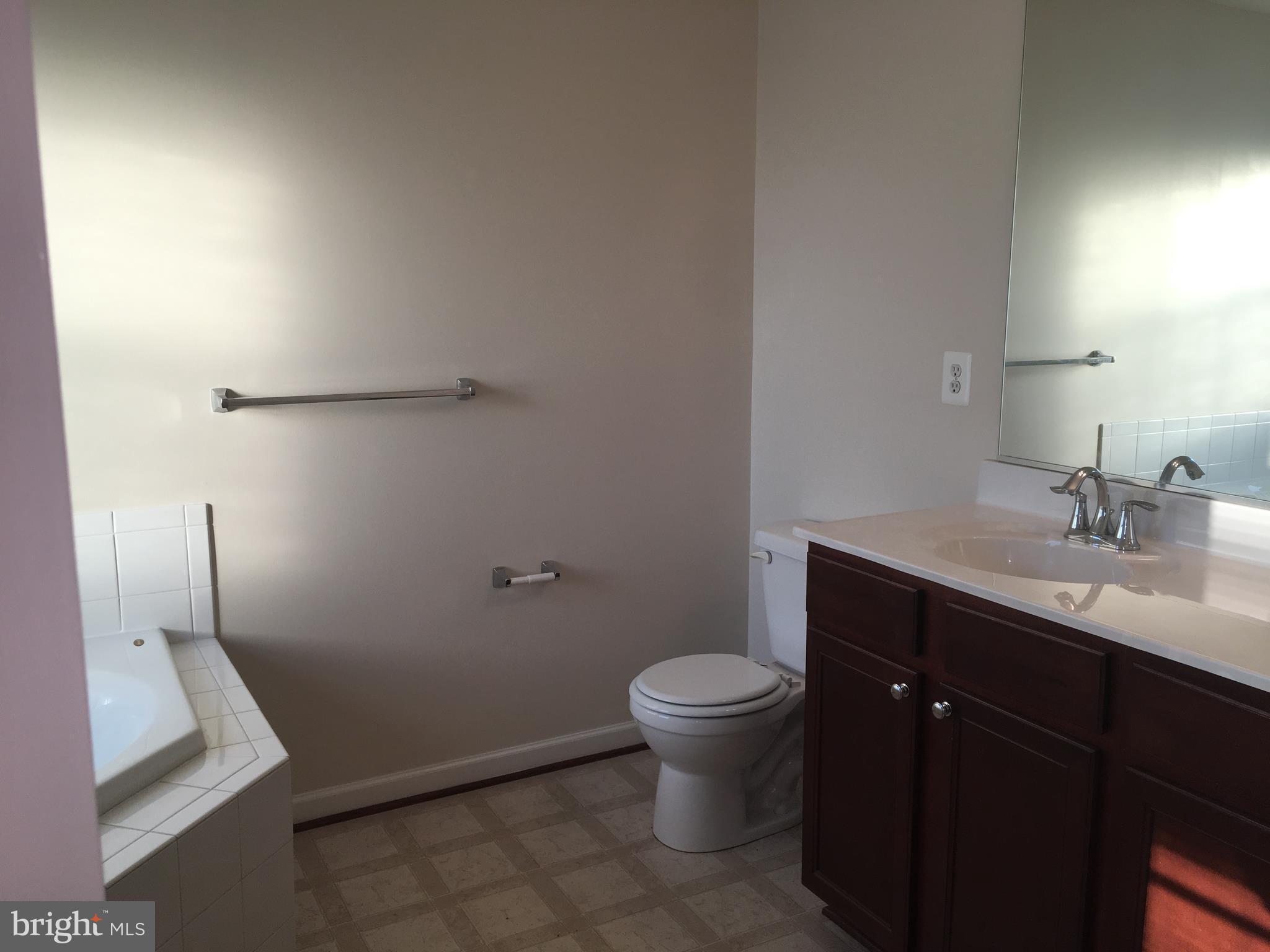 9609 Davison Road Baltimore, MD 21220 - Photo 9 of 21 a bathroom with a sink toilet and vanity
