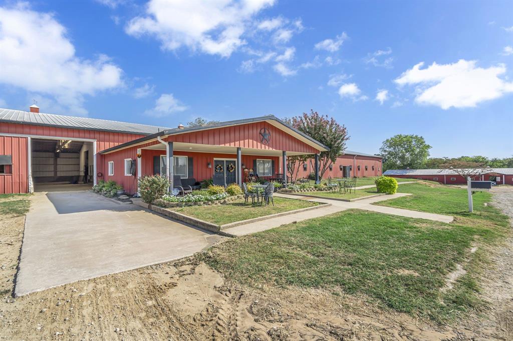 7950 Cross Timbers Road Flower Mound, TX 75022 - Photo 2 of 37 a front view of house with yard and trees in the background