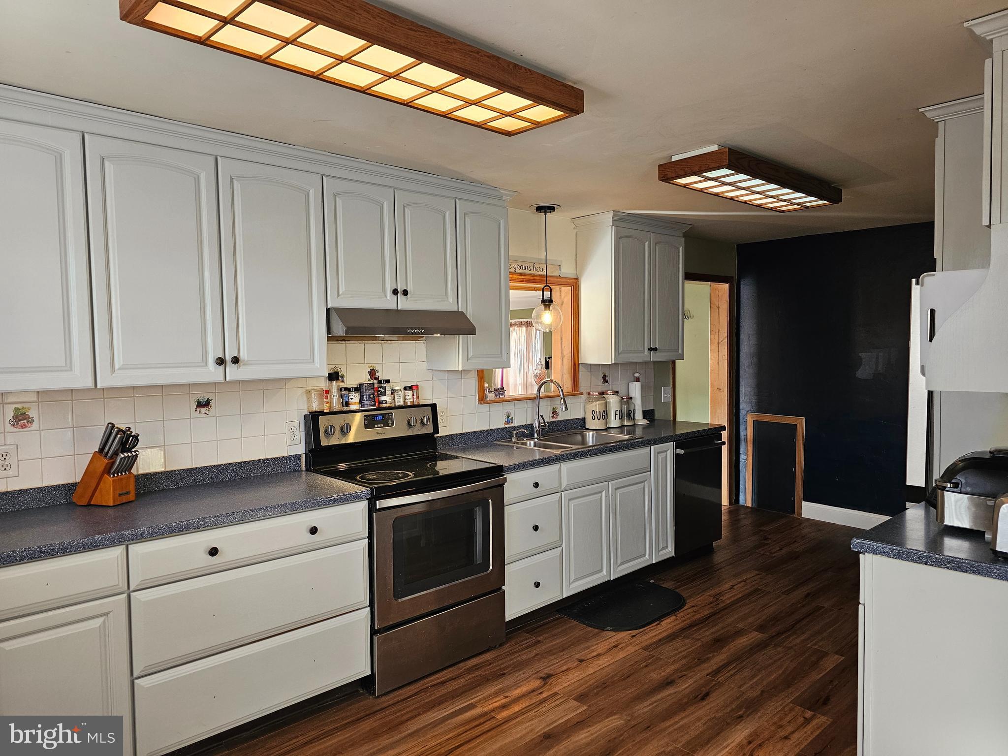 57 Union Street Pennsville, NJ 08070 - Photo 6 of 24 a kitchen with granite countertop stainless steel appliances a stove a sink and cabinets