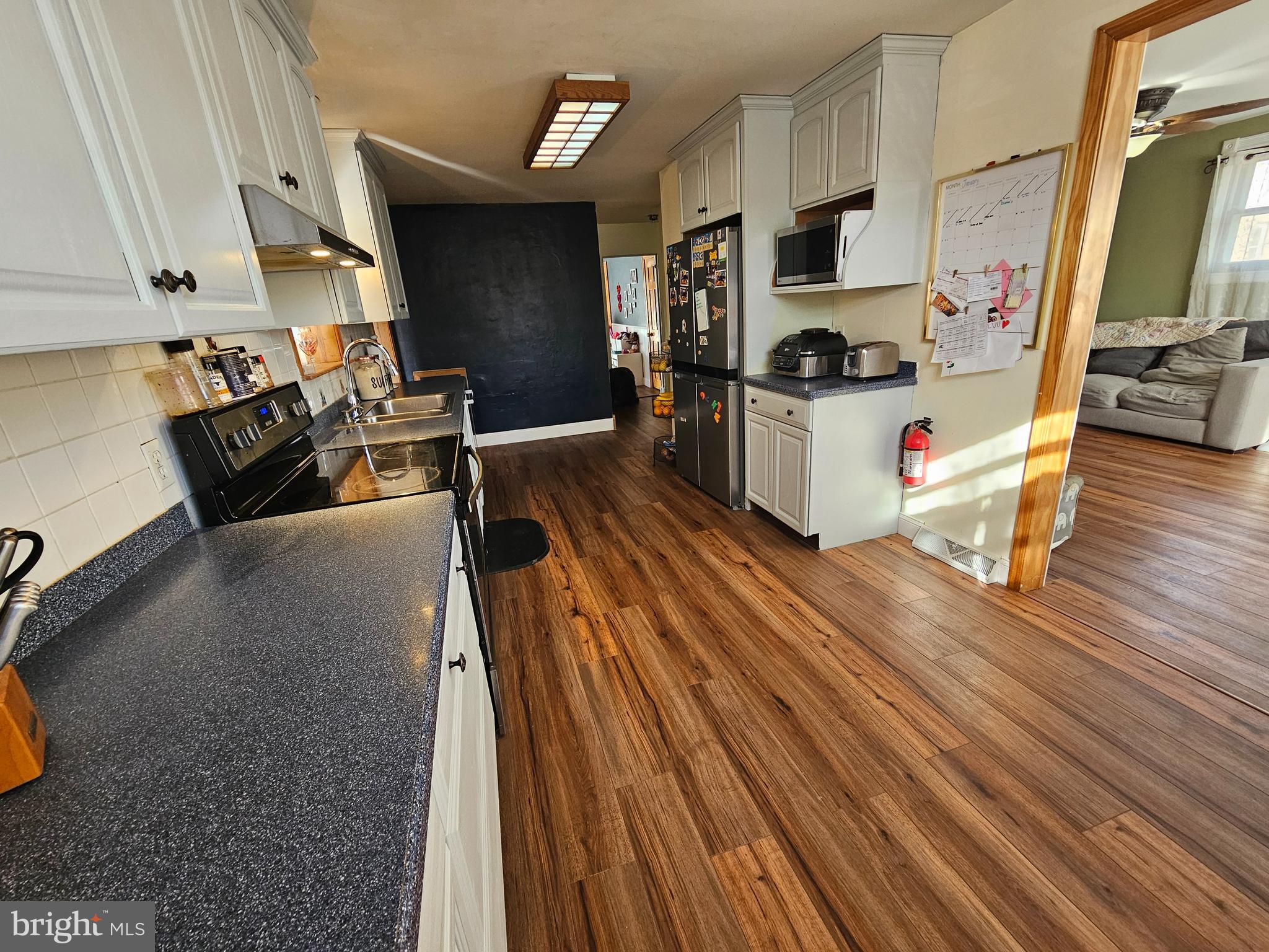 57 Union Street Pennsville, NJ 08070 - Photo 7 of 24 a living room with stainless steel appliances furniture and a wooden floor