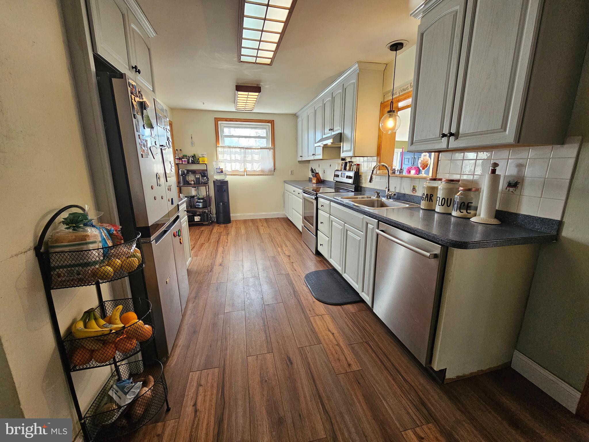 57 Union Street Pennsville, NJ 08070 - Photo 8 of 24 a kitchen with granite countertop a sink dishwasher stove and wooden floor