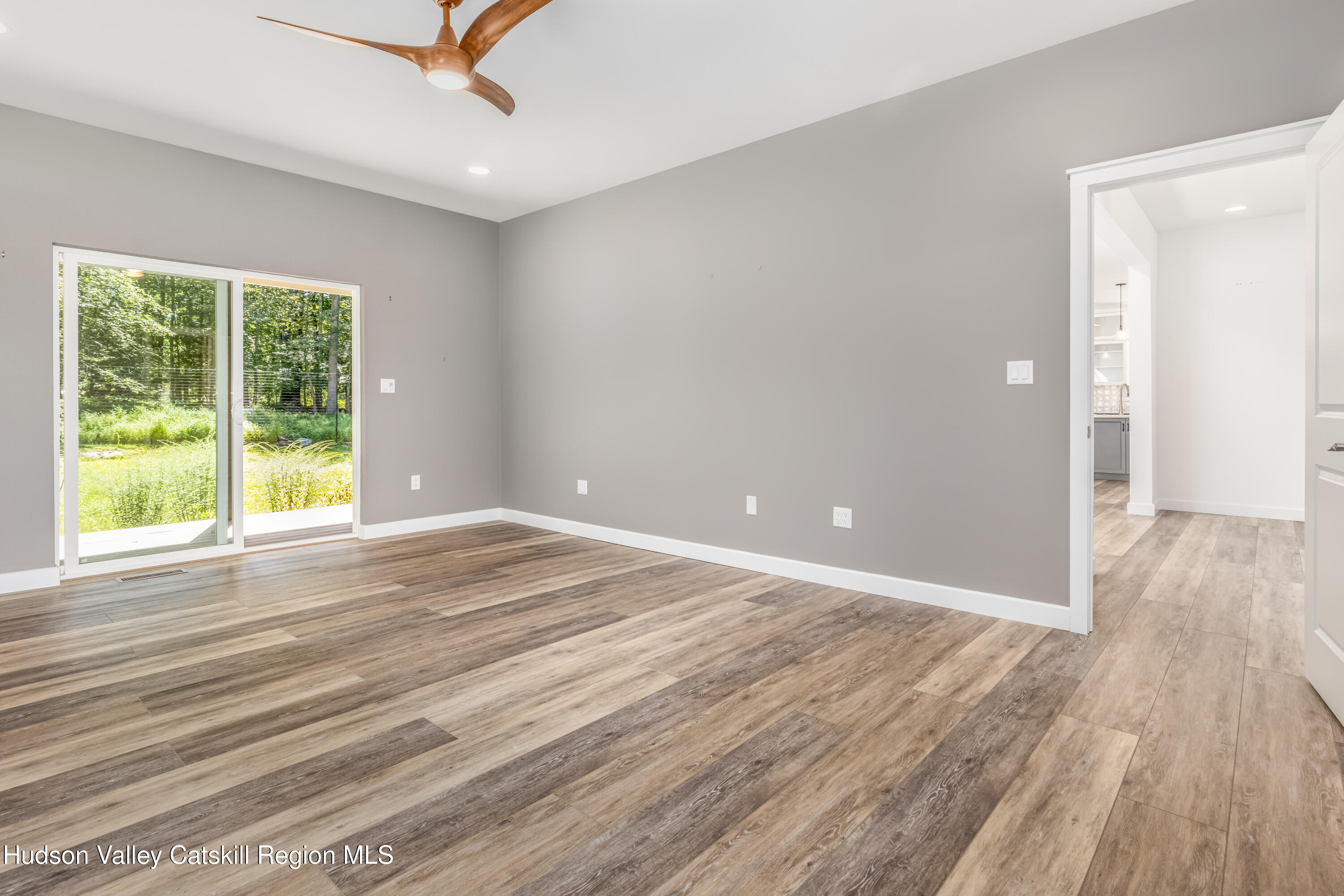 621 Decker Road Wallkill, NY 12589 - Photo 19 of 44 a view of an empty room with wooden floor and a window