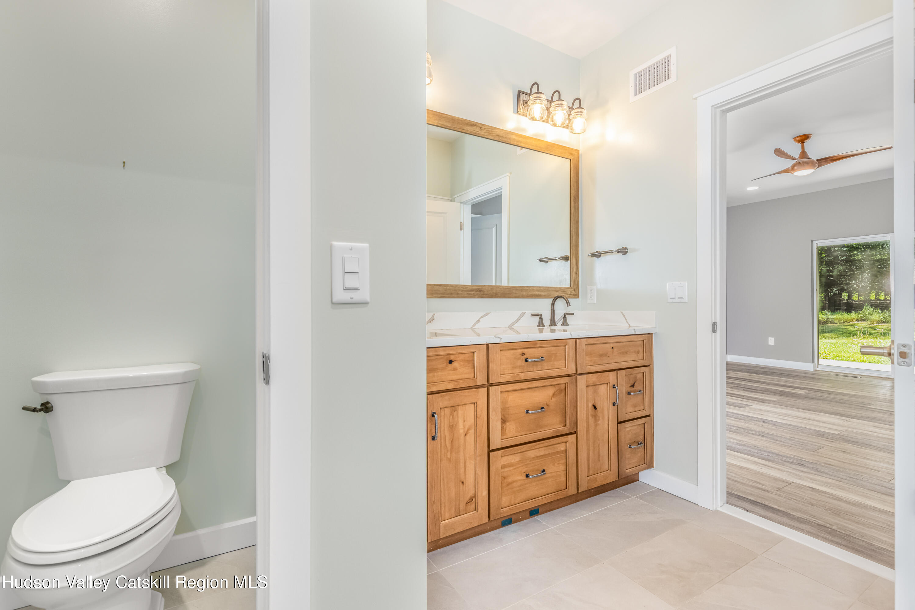 621 Decker Road Wallkill, NY 12589 - Photo 22 of 44 a spacious bathroom with a granite countertop toilet sink and a mirror