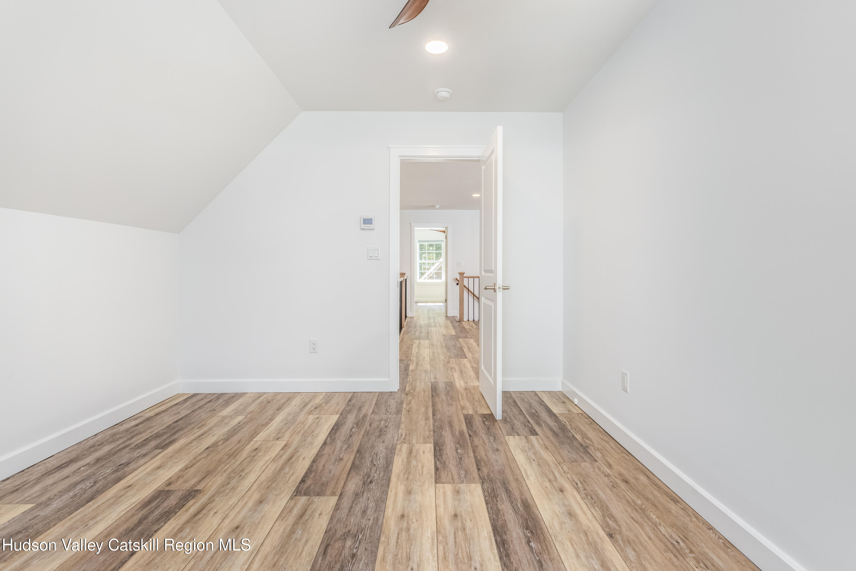 621 Decker Road Wallkill, NY 12589 - Photo 32 of 44 a view of a room with wooden floor and a ceiling fan