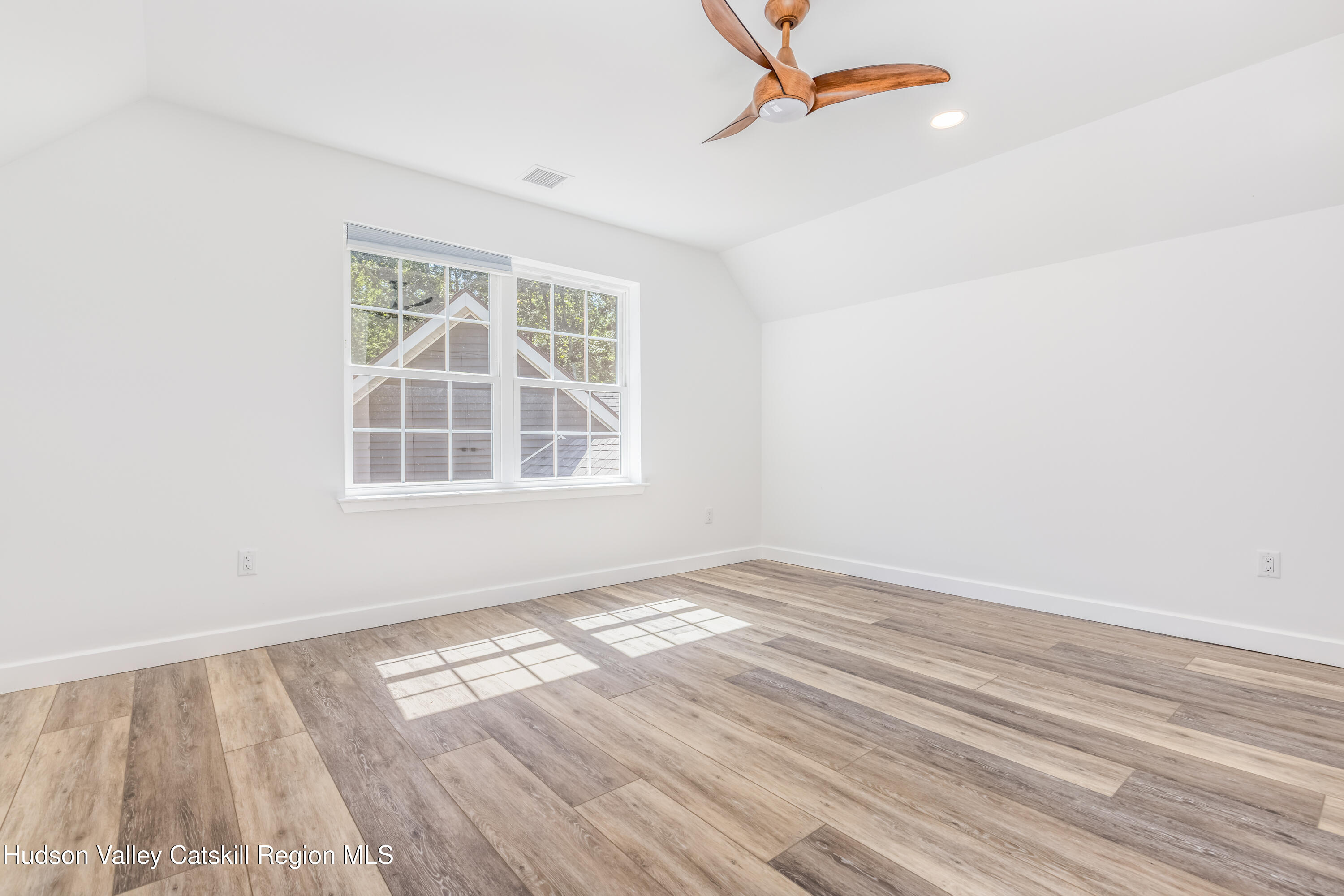 621 Decker Road Wallkill, NY 12589 - Photo 35 of 44 an empty room with wooden floor cabinet and windows