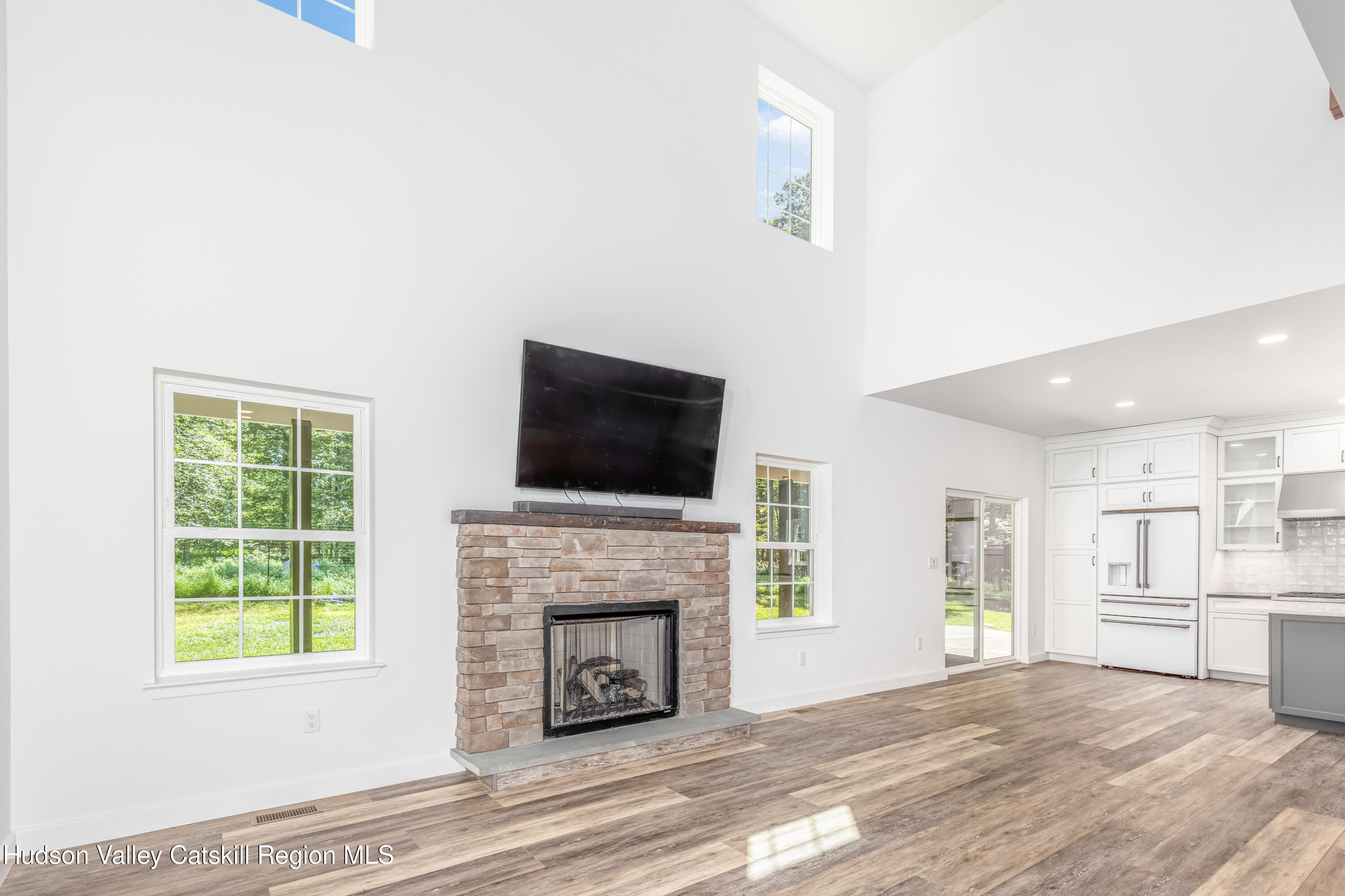 621 Decker Road Wallkill, NY 12589 - Photo 10 of 44 a view of a livingroom with a fireplace a ceiling fan and windows
