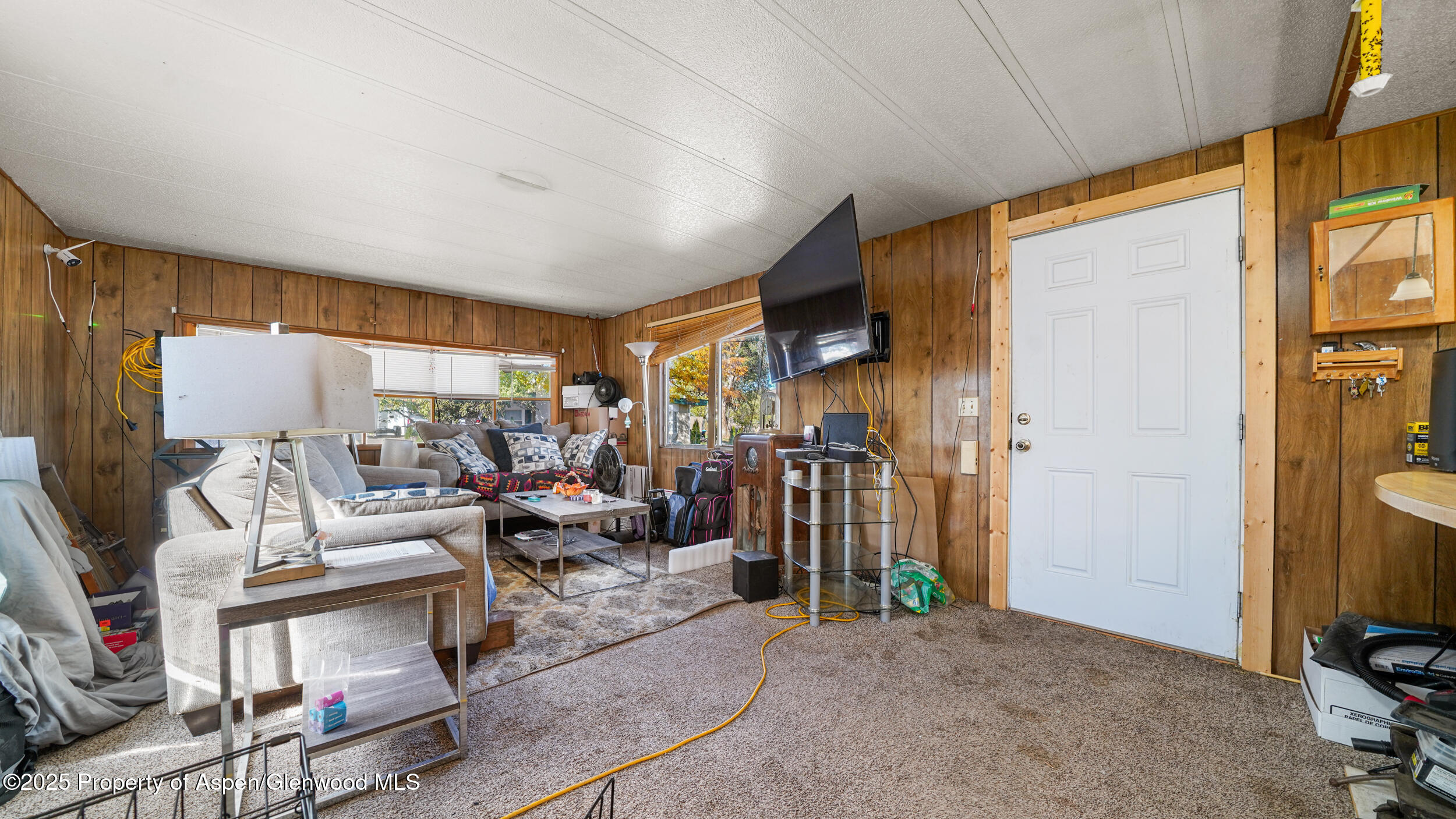 1501 Railroad Avenue, Unit 37 Rifle, CO 81650 - Photo 5 of 18 a living room with furniture a flat screen tv and a window