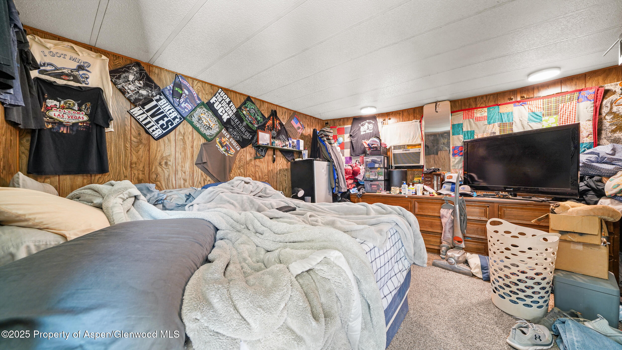 1501 Railroad Avenue, Unit 37 Rifle, CO 81650 - Photo 9 of 18 a bedroom with a bed and a flat screen tv