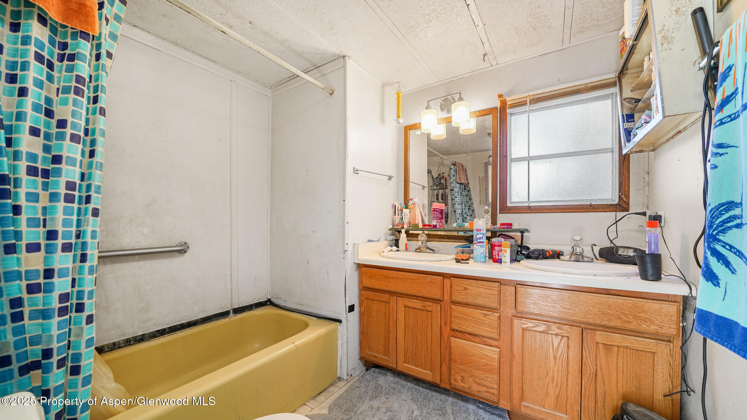 1501 Railroad Avenue, Unit 37 Rifle, CO 81650 - Photo 10 of 18 a bathroom with a tub sink and mirror