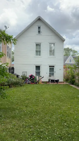 a view of a backyard with plants and a garden
