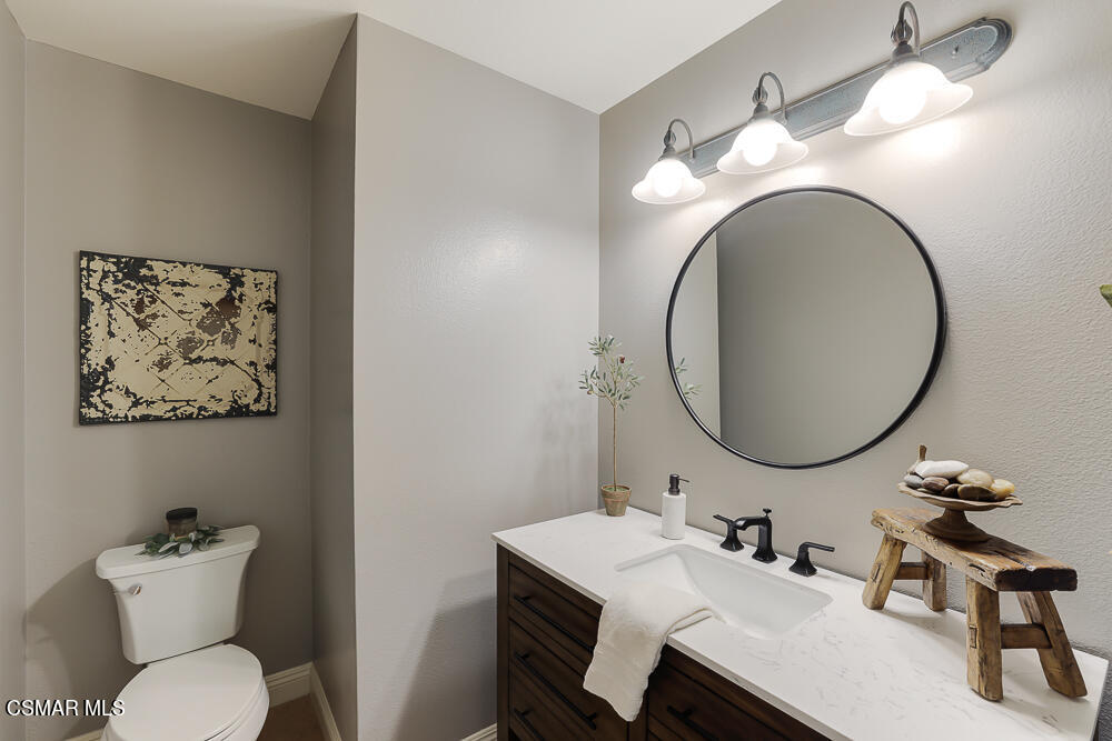4051 Doneva Road Moorpark, CA 93021 - Photo 19 of 52 a bathroom with a toilet a sink and mirror
