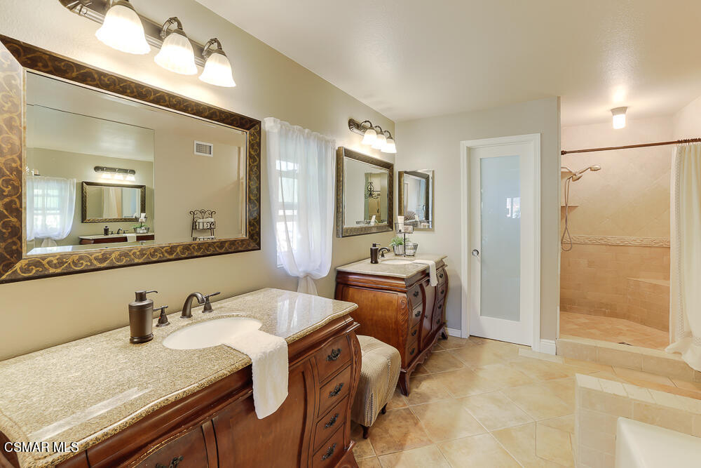 4051 Doneva Road Moorpark, CA 93021 - Photo 35 of 52 a en suite bathroom with a granite countertop sink and a mirror