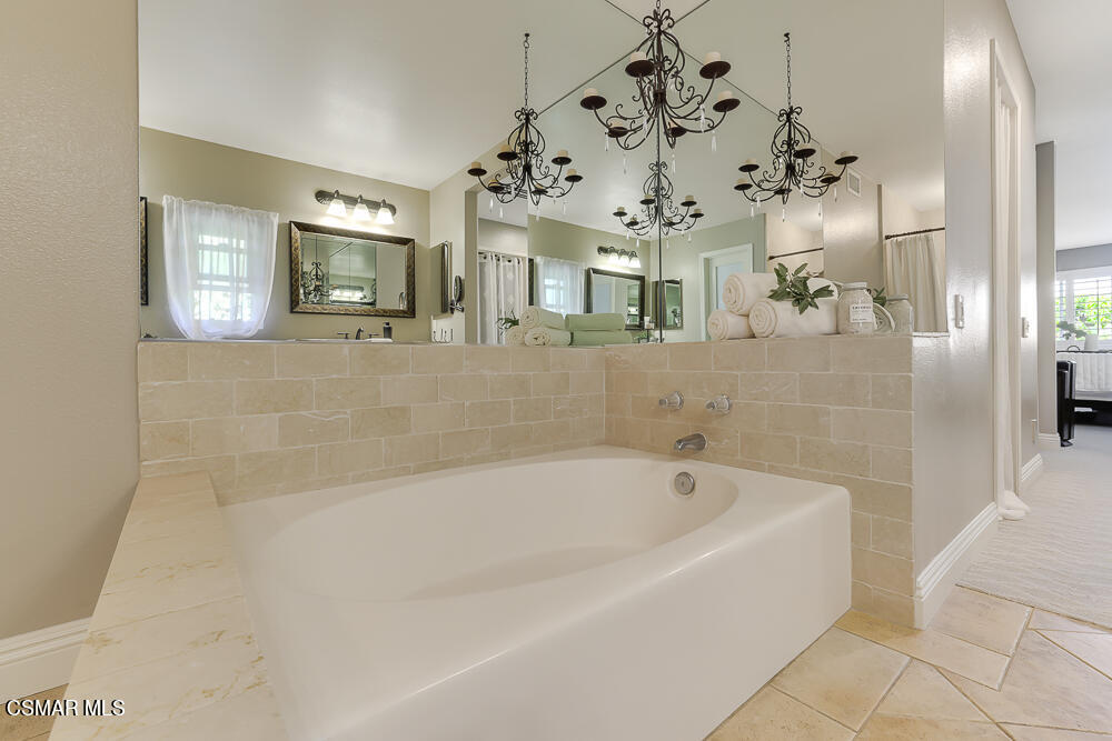 4051 Doneva Road Moorpark, CA 93021 - Photo 37 of 52 a spacious bathroom with a bathtub a mirror and a shower