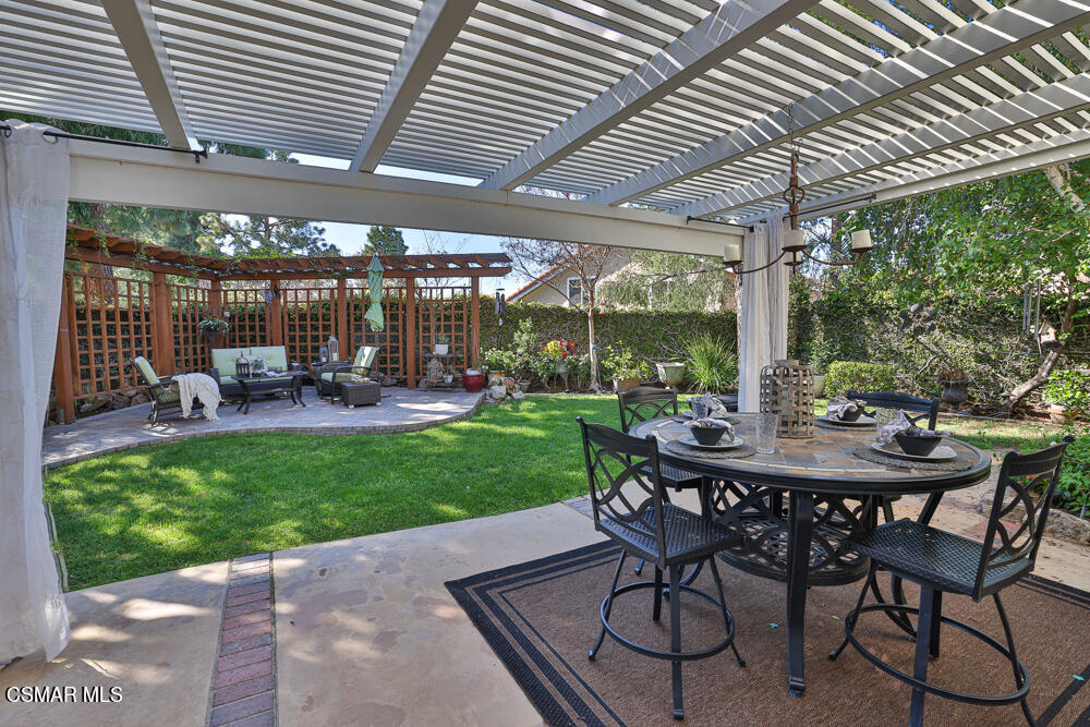 4051 Doneva Road Moorpark, CA 93021 - Photo 39 of 52 a view of a patio with a table chairs and a backyard