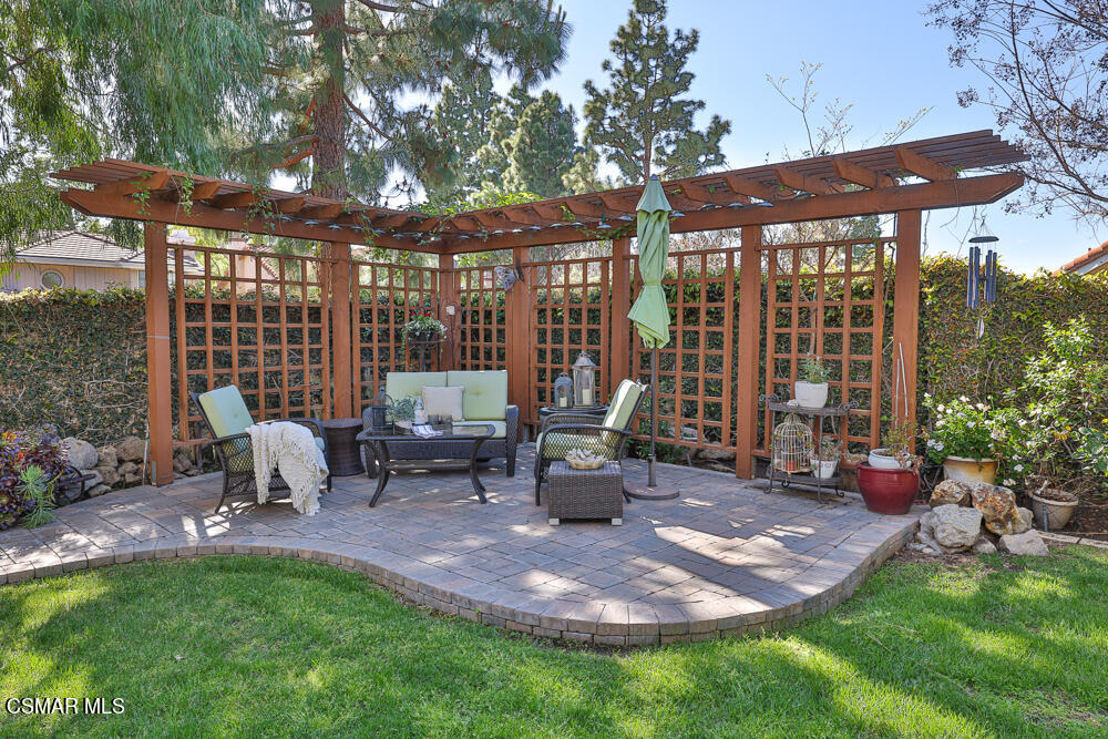 4051 Doneva Road Moorpark, CA 93021 - Photo 40 of 52 a view of a patio with table and chairs potted plants and floor to ceiling window