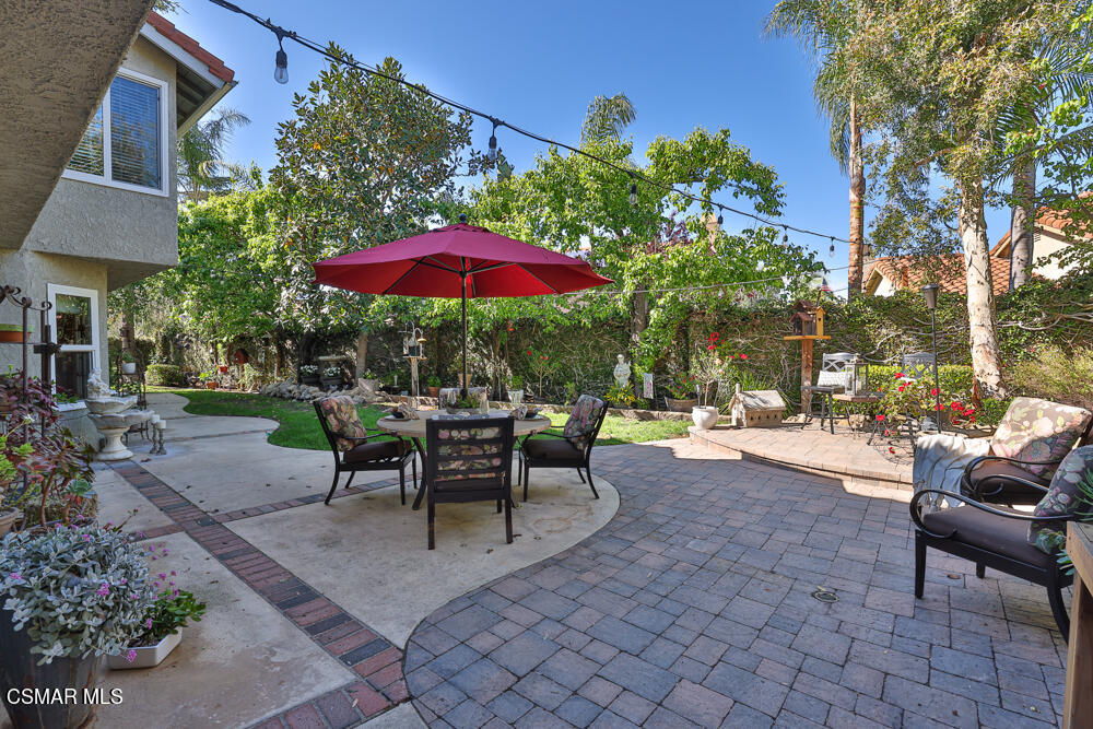 4051 Doneva Road Moorpark, CA 93021 - Photo 44 of 52 a view of a patio with a table and chairs under an umbrella