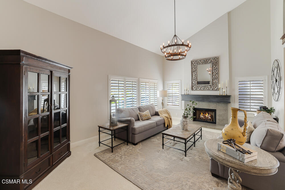 4051 Doneva Road Moorpark, CA 93021 - Photo 7 of 52 a living room with furniture a fireplace and a chandelier