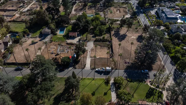 an aerial view of a house a yard and mountain