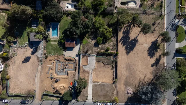 an aerial view of a house with a yard