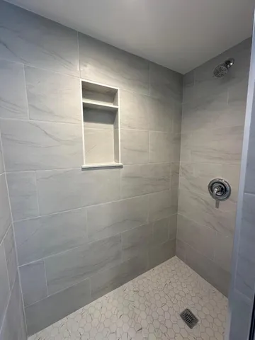 a bathroom with a glass door and shower
