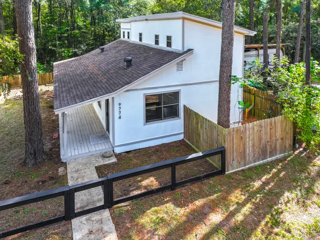a view of backyard with deck and outdoor seating