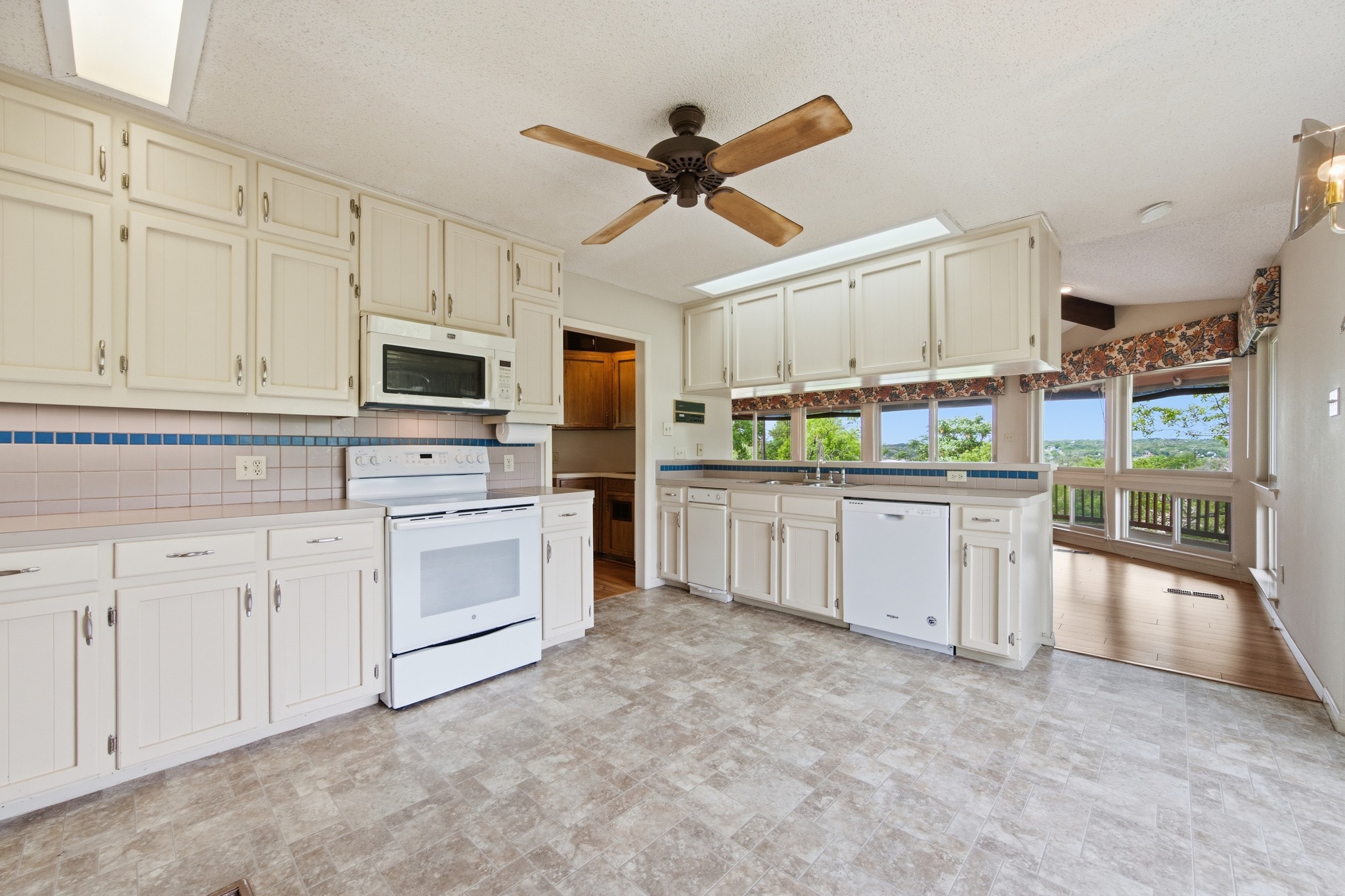 4831 Eck Lane Austin, TX 78734 - Photo 16 of 27 a kitchen with white cabinets and white appliances