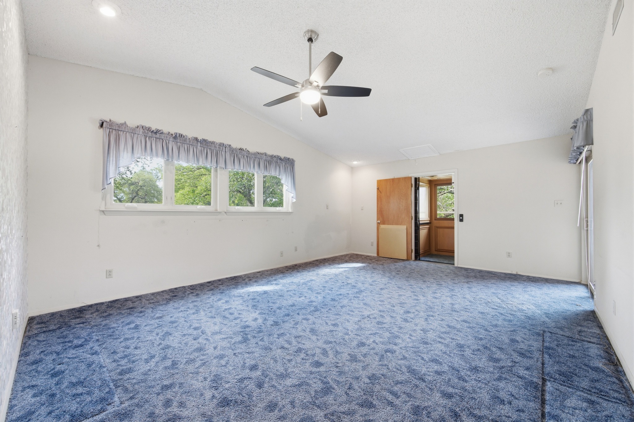 4831 Eck Lane Austin, TX 78734 - Photo 17 of 27 an empty room with a ceiling fan and a window