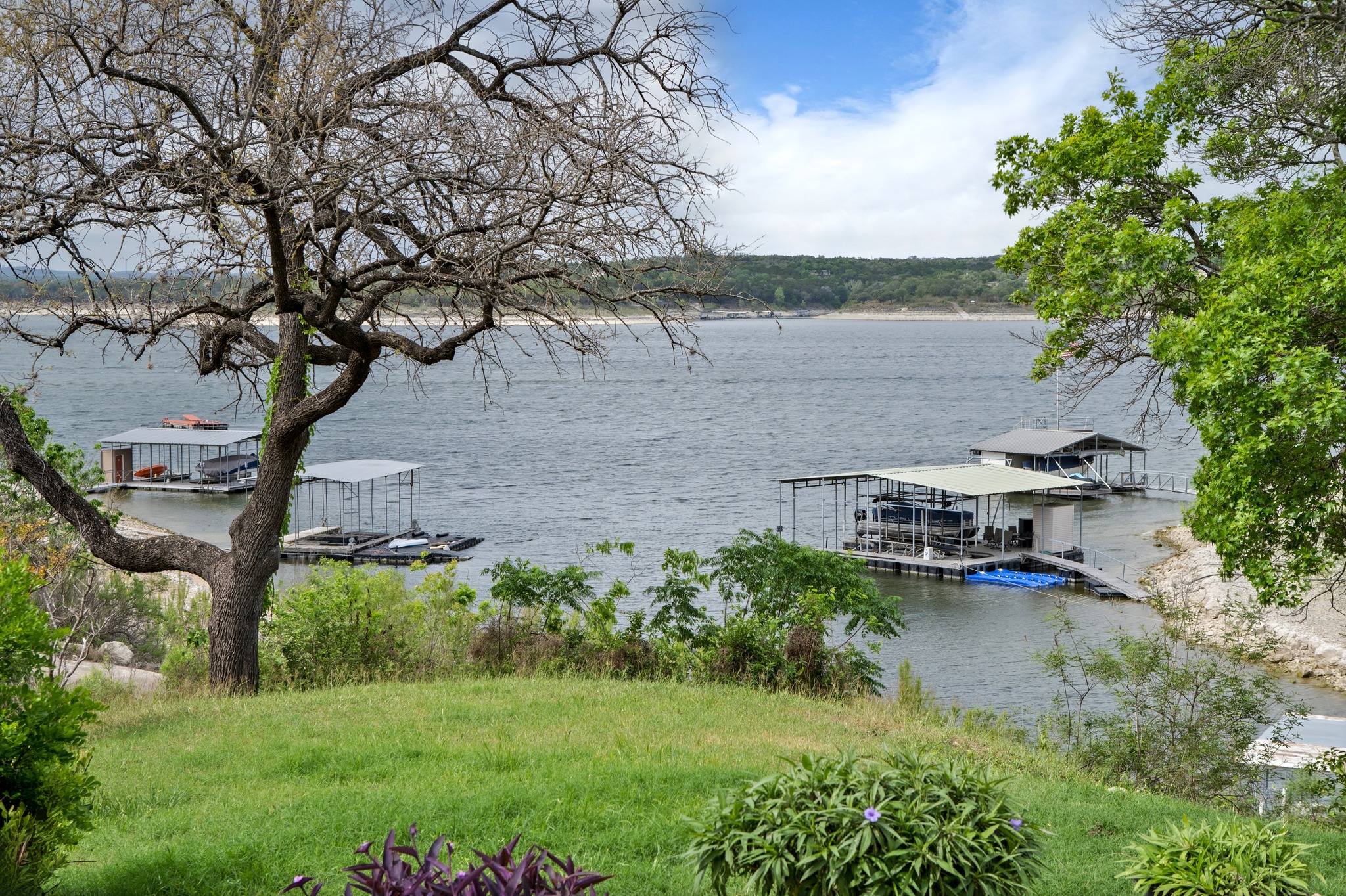 4831 Eck Lane Austin, TX 78734 - Photo 23 of 27 a backyard of a house with lots of green space and lake view