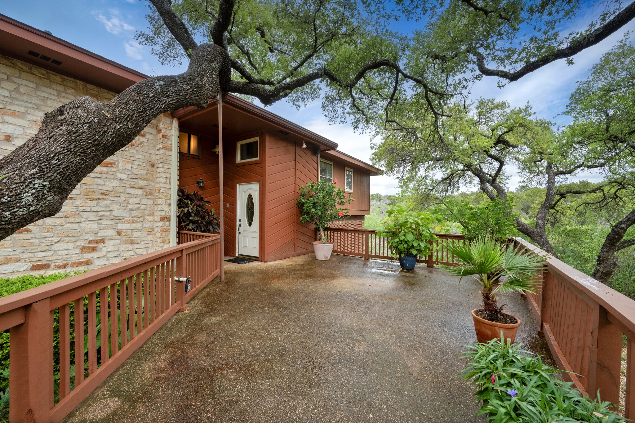 4831 Eck Lane Austin, TX 78734 - Photo 6 of 27 a view of a porch with wooden stairs and a bench