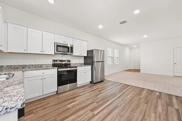 a kitchen with a refrigerator stove and microwave