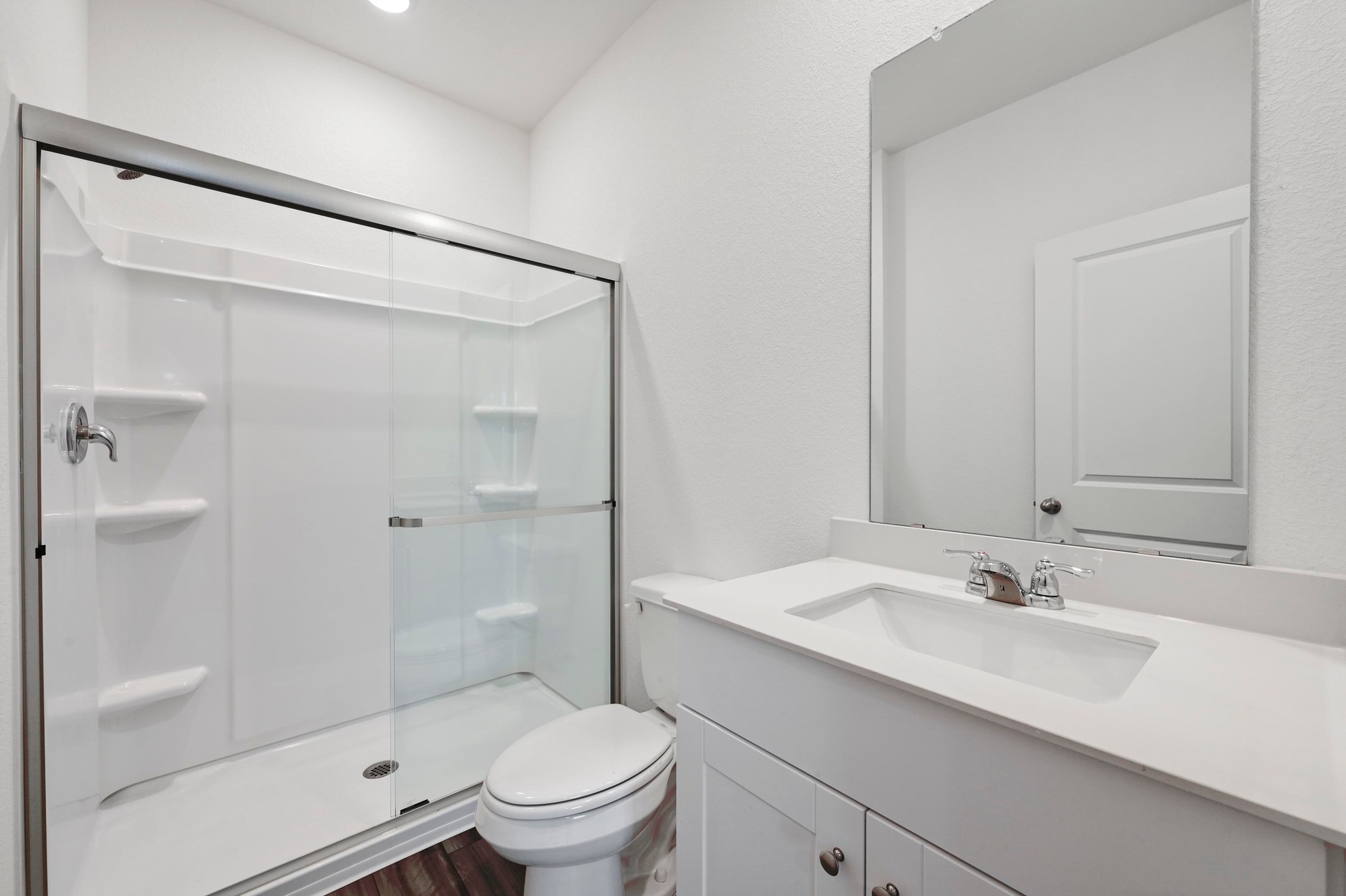 473 Thistle Lane Maxwell, TX 78656 - Photo 15 of 25 Full bath featuring vanity, a stall shower, and dark wood finished floors