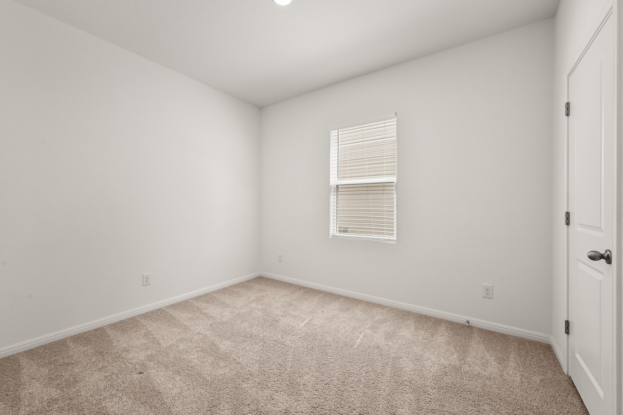 473 Thistle Lane Maxwell, TX 78656 - Photo 18 of 25 Empty room with light carpet and baseboards