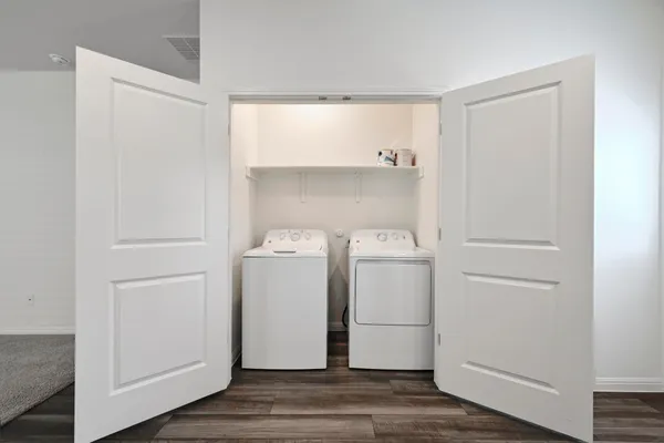 a bathroom with a sink a toilet and a large mirror