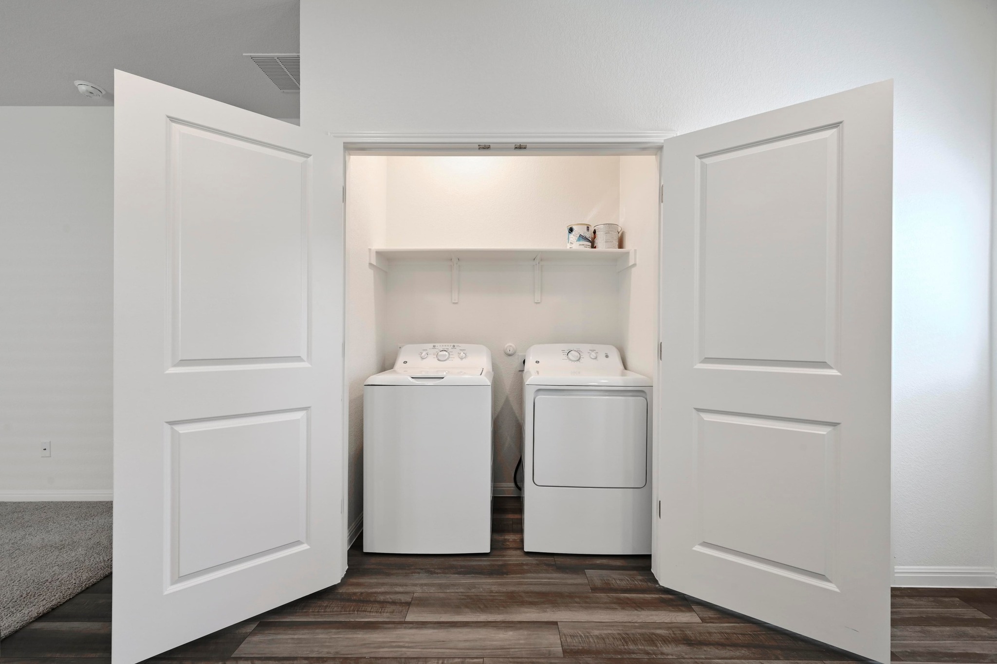 473 Thistle Lane Maxwell, TX 78656 - Photo 20 of 25 Laundry area with dark wood finished floors and washing machine and dryer