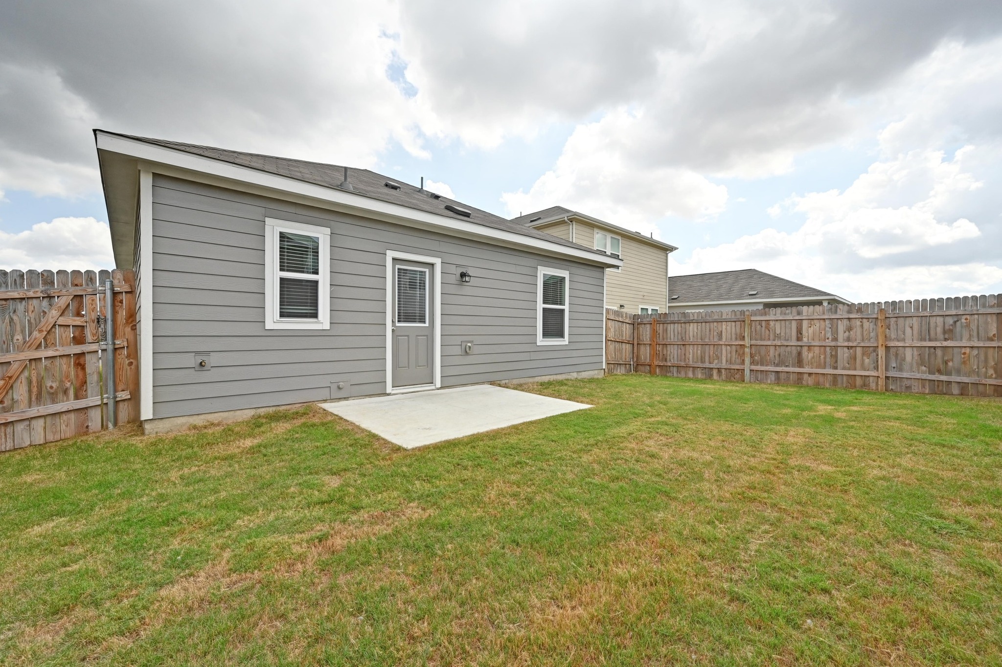 473 Thistle Lane Maxwell, TX 78656 - Photo 22 of 25 Back of property featuring a patio area and a fenced backyard