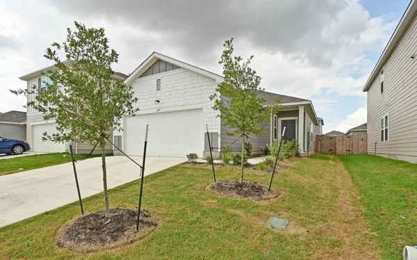 a view of a house with a backyard