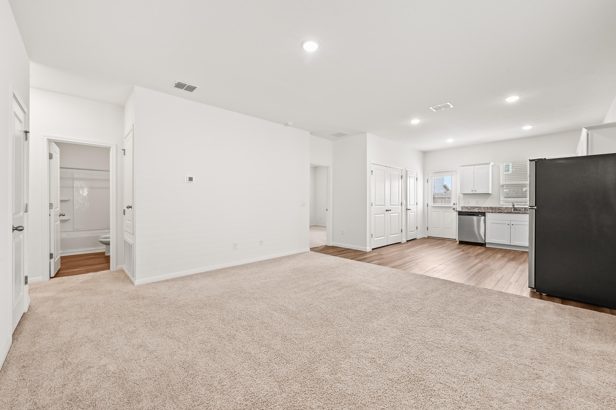 473 Thistle Lane Maxwell, TX 78656 - Photo 5 of 25 Unfurnished living room with light colored carpet and recessed lighting