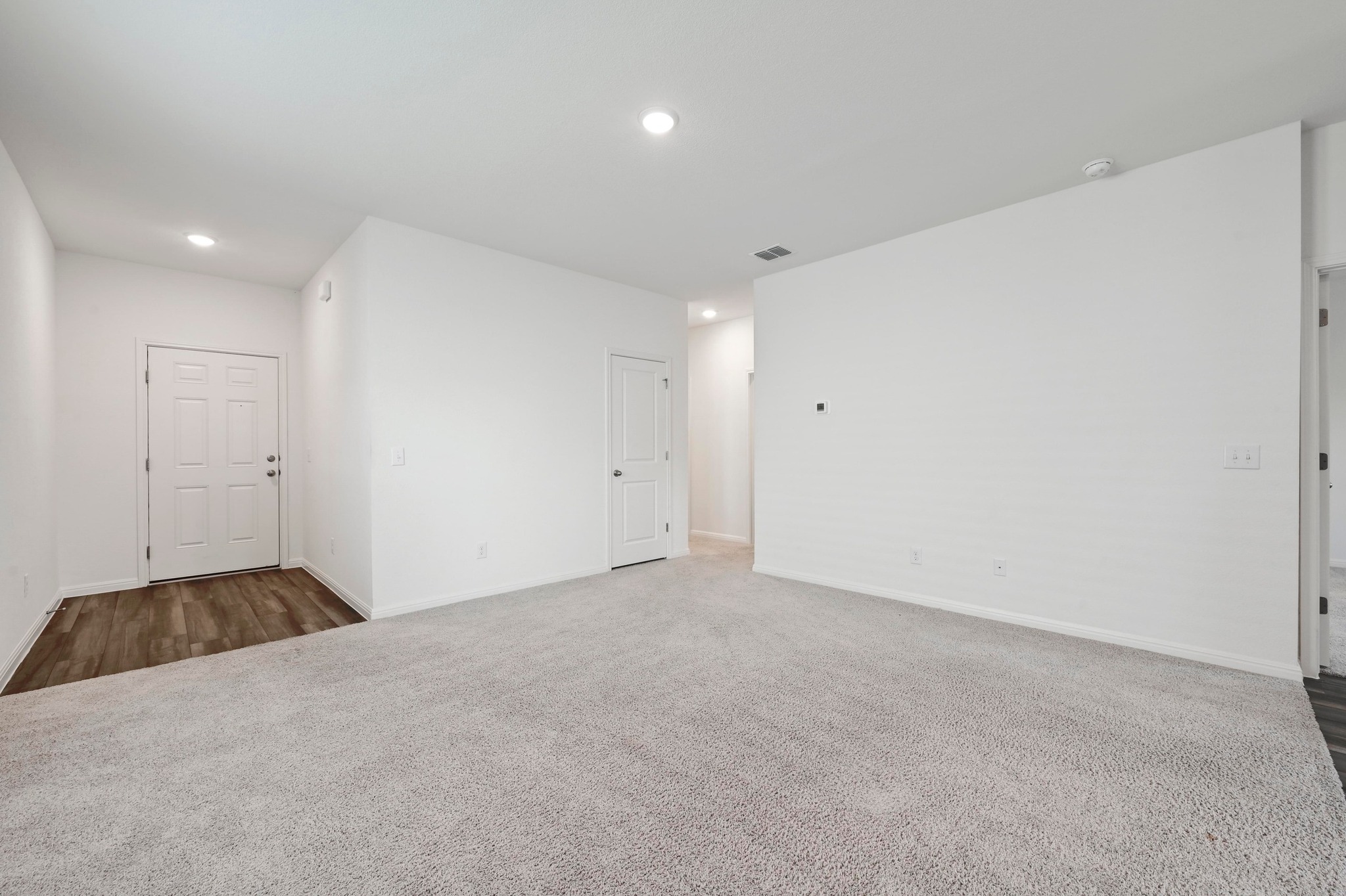 473 Thistle Lane Maxwell, TX 78656 - Photo 8 of 25 Empty room featuring dark carpet and recessed lighting