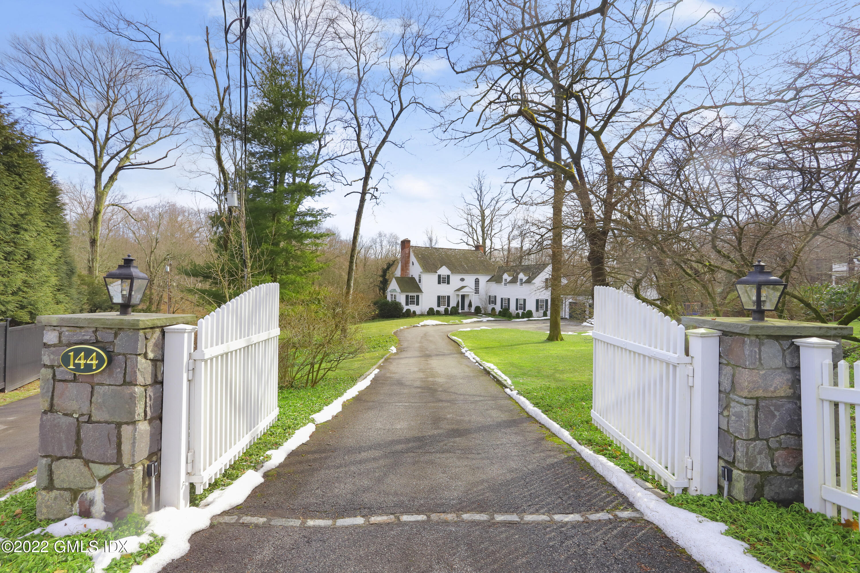 144 Pecksland Road Greenwich, CT 06831 - Photo 2 of 49 a view of a pathway with a wrought fence