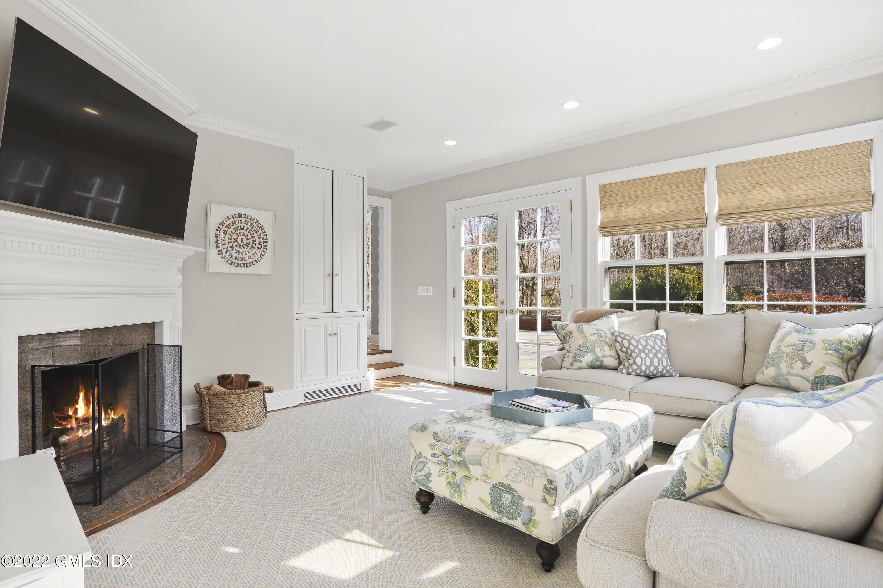 144 Pecksland Road Greenwich, CT 06831 - Photo 21 of 49 a living room with furniture a fireplace and a flat screen tv