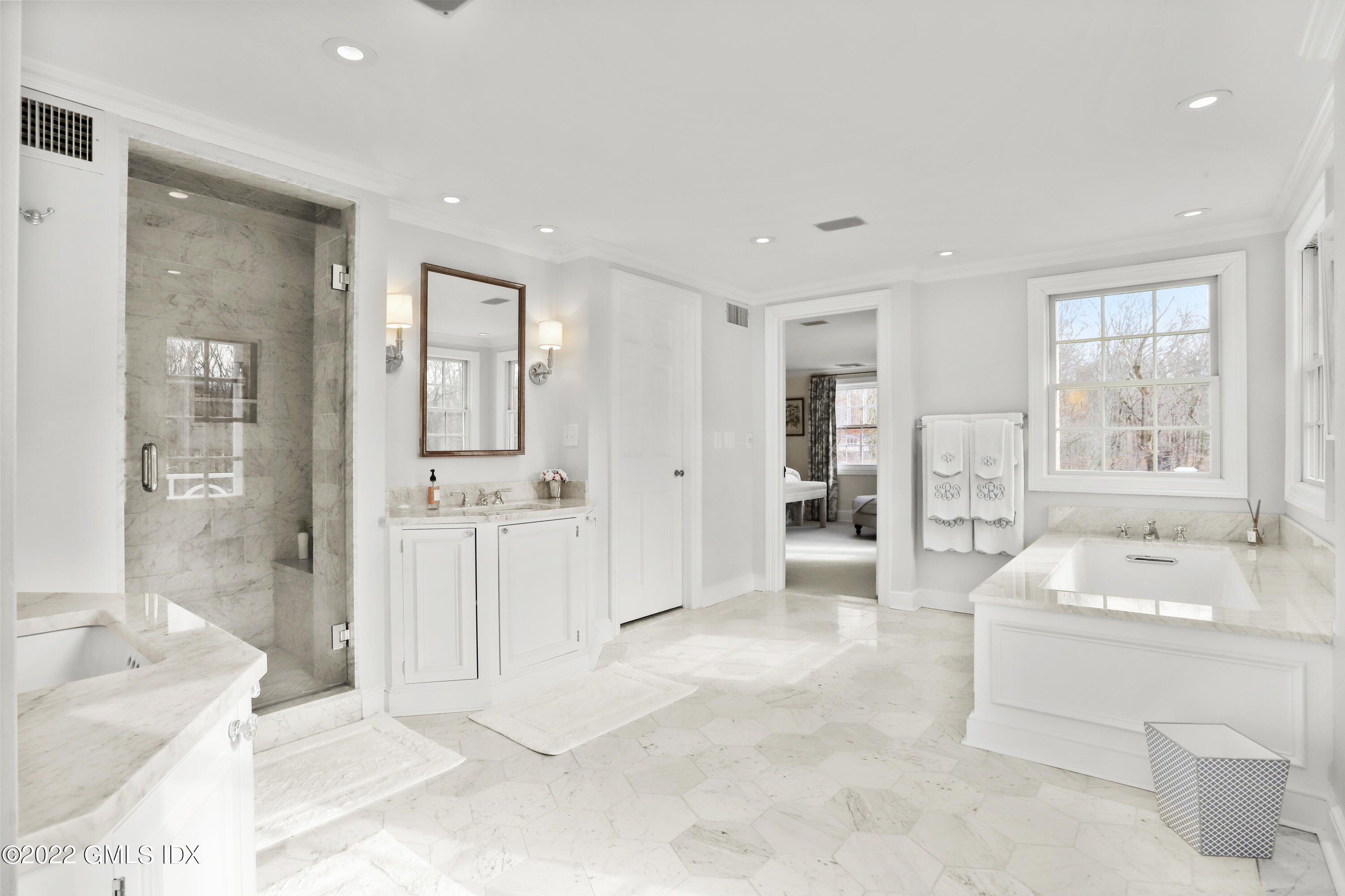 144 Pecksland Road Greenwich, CT 06831 - Photo 27 of 49 a bathroom with a tub sink and mirror