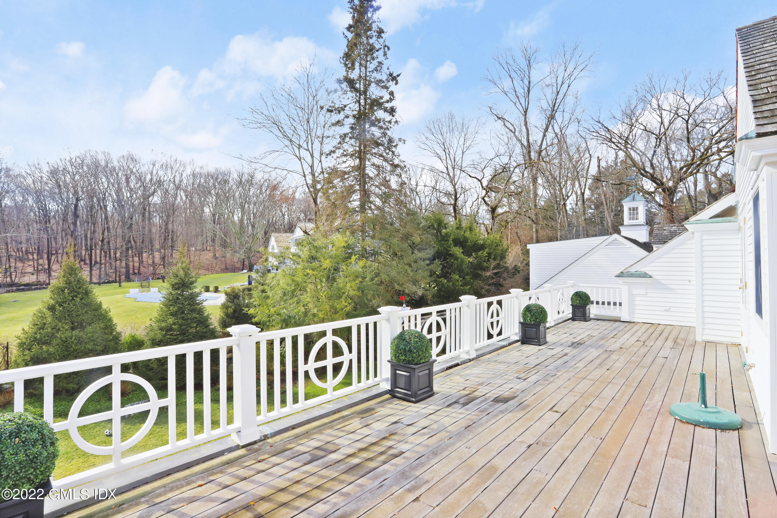 144 Pecksland Road Greenwich, CT 06831 - Photo 35 of 49 a view of a wooden deck with a yard