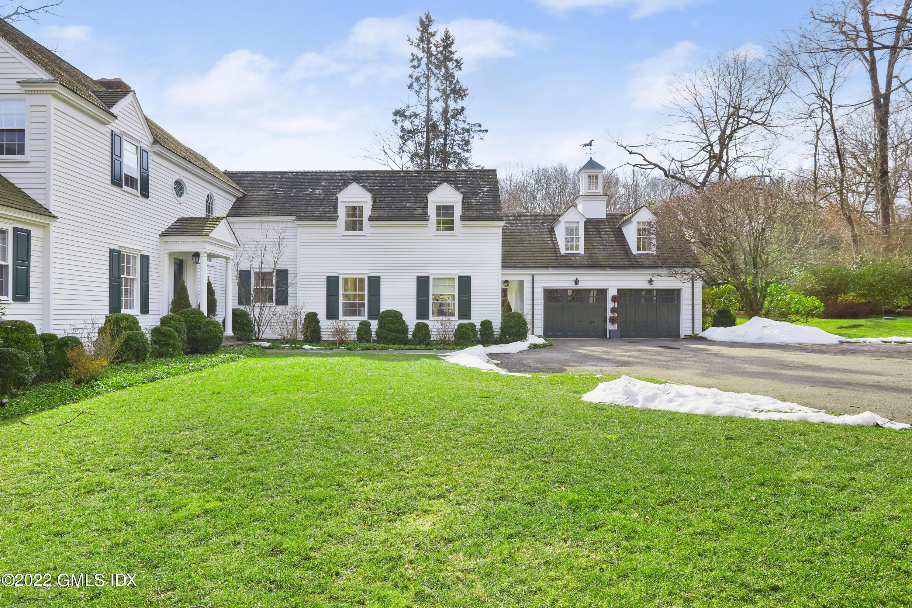 144 Pecksland Road Greenwich, CT 06831 - Photo 5 of 49 a front view of a house with a yard and street view