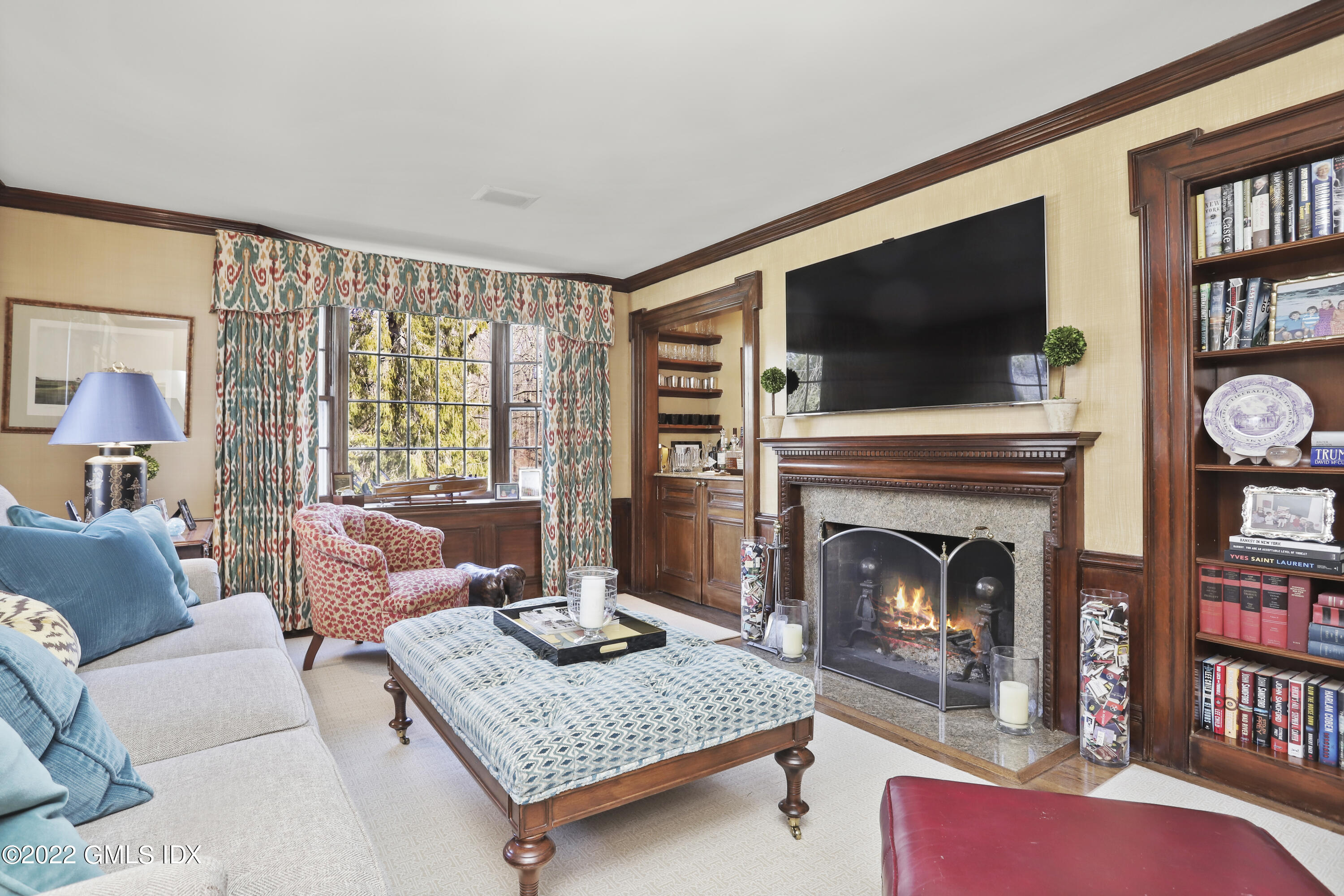 144 Pecksland Road Greenwich, CT 06831 - Photo 9 of 49 a living room with furniture a flat screen tv and a fireplace