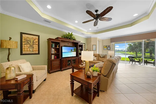 a living room with furniture and a flat screen tv with wooden floor