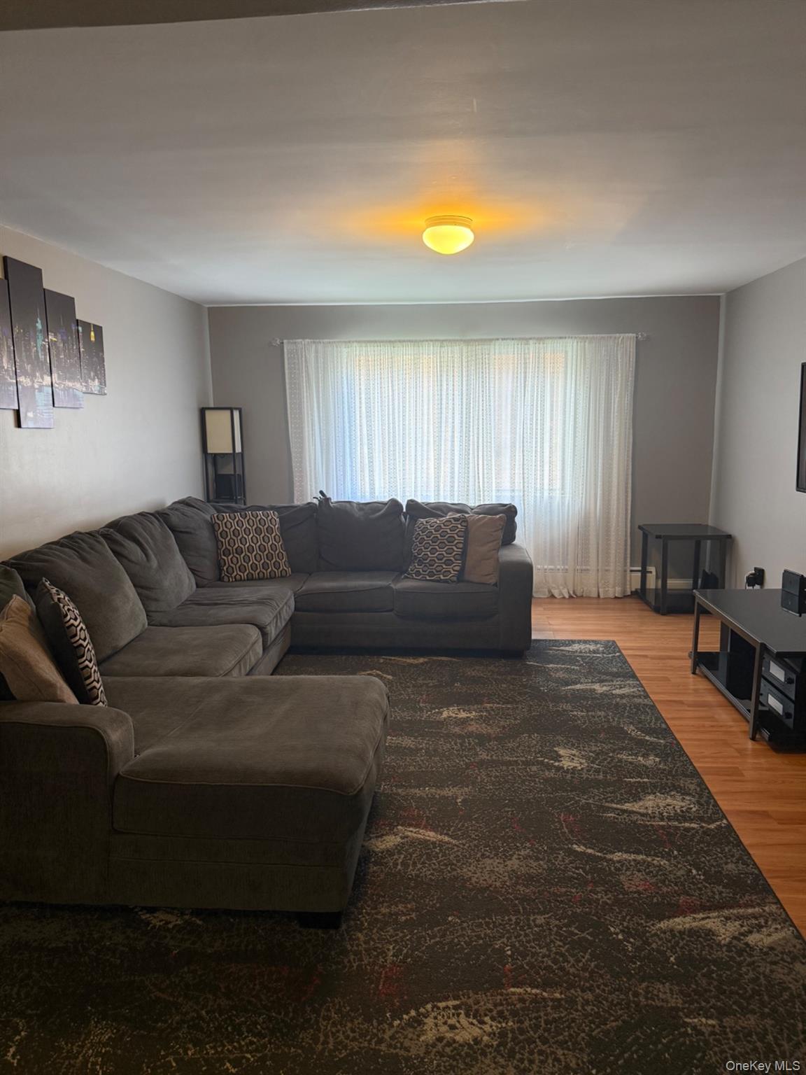 a living room with a couch and a window